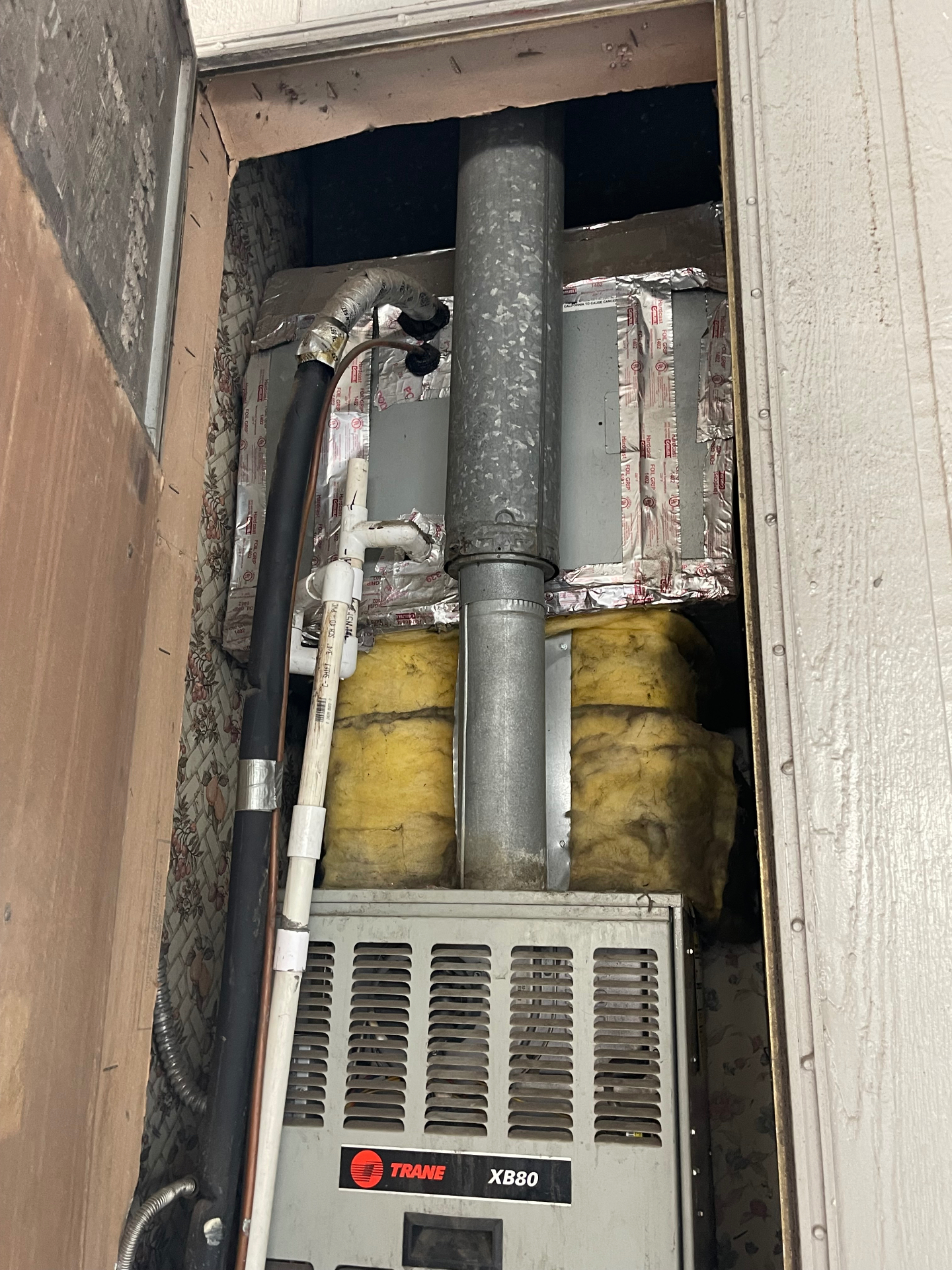 Trane XB80 furnace with insulated plenum and flue in a hallway closet